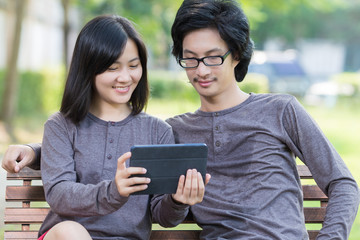 Couple Use Tablet at Park