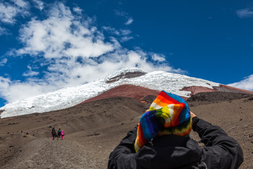 Cotopaxi volcano with some tourists ascending by its sandbanks