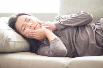 Woman Has Toothache Lying on Sofa