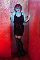 girl with makeup zombies standing in red wall