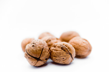close up of group of walnuts on bright white background