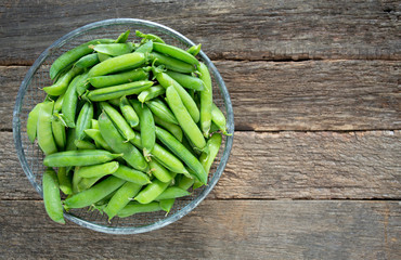 pea pods on wooden surface