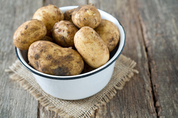 potatoes on wooden surface