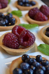 Fruit tarts. Round pastry with red and black berries.