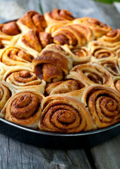 cinnamon buns on wooden surface