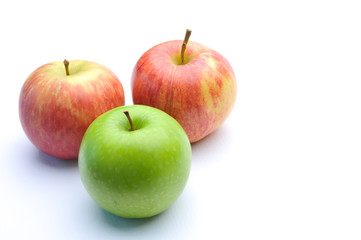 different concepts - green apple between red apples