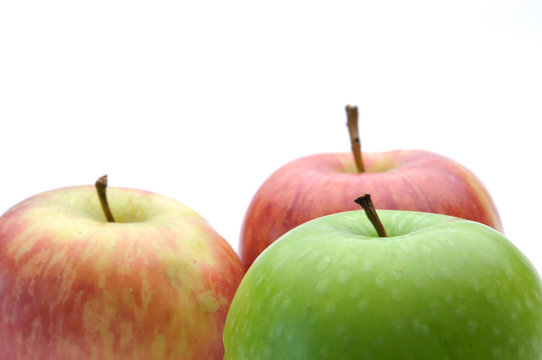 different concepts - green apple between red apples