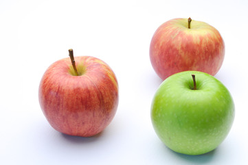 different concepts - green apple between red apples