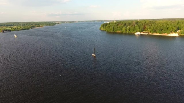 Sailing boat on the lake, the beautiful landscape, sky, clouds.Aerial view:Yacht on the surface of the lake on a sunny day.