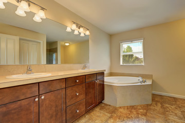 Great bathroom interior with corner bath tub and marble floor