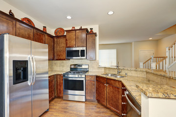 Kitchen interior with steel appliances and granite counter tops