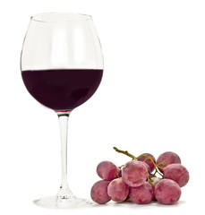 Photo of glass of red wine with bunch of grapes