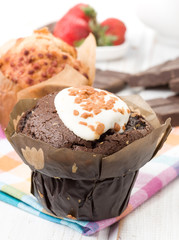 appetizing black muffins, on wood