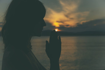 Young woman practicing yoga on the beach.

