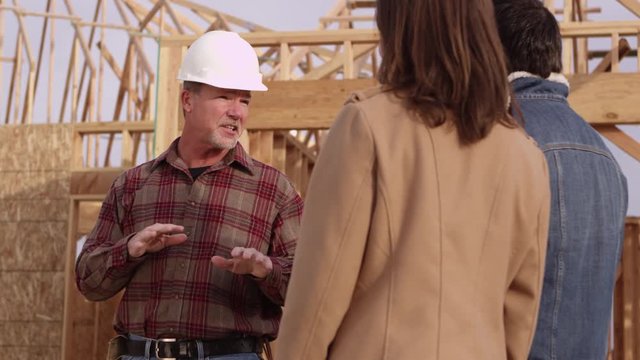 Couple speaking to contractor