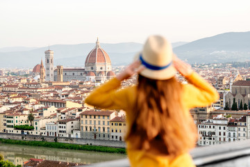 Young female tourist enjoying the view on the old town of Florence from Michelangelo square in the...