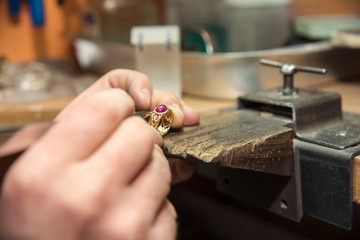 jeweler makes a piece of jewelry 