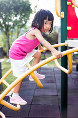 Asian Chinese little girl climbing at playground