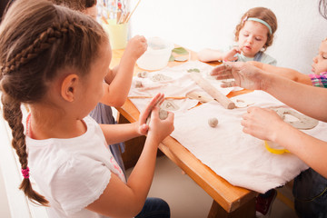 Happy children are engaged with modeling clay