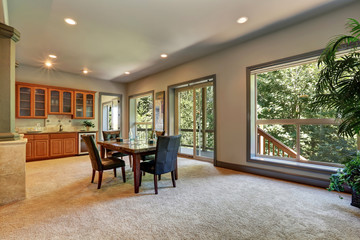 Open floor plan dining room with view of kitchen cabinetry
