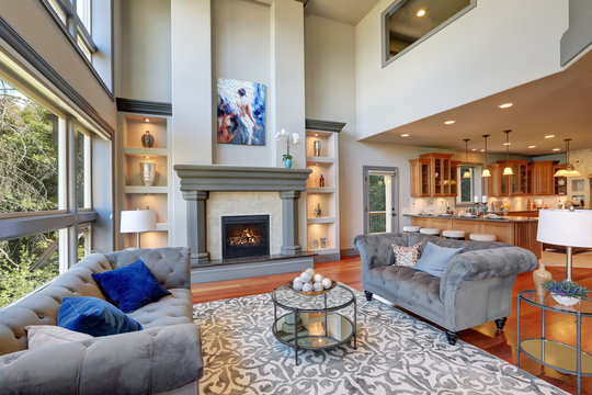 Grey interior of high vaulted ceiling family room.