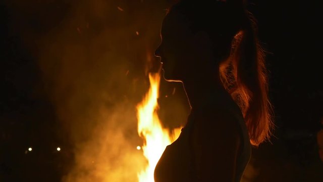 Profile of a woman on a background of a fire