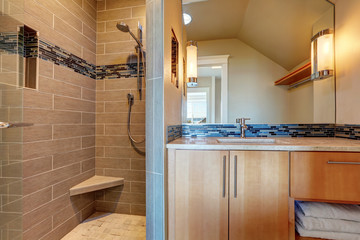 Modern mocha bathroom interior design with tile wall trim.