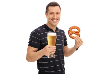 Fototapeta premium Man holding a pretzel and a beer