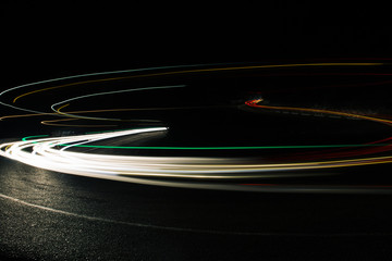 Exposured bright red and white lines from car riding on night road