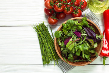 Fresh green salad with spinach ,ruccola,lettuce on wooden table.
