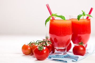 Tomato Juice and Fresh Tomatoes on a White Wooden Background