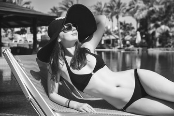  woman with hat near the swimming pool