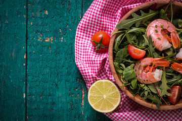 Green salad with shrimps on wooden table.healthy food