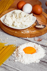 cooking spaghetti on a wooden background milk eggs