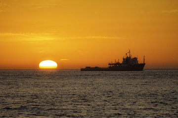 Fishing trawler at sunrise