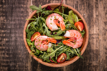 Green salad with shrimps on wooden table.healthy food