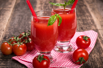 Tomato Juice and Fresh Tomatoes on a Wooden Background