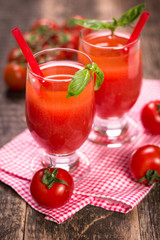Tomato Juice and Fresh Tomatoes on a Wooden Background