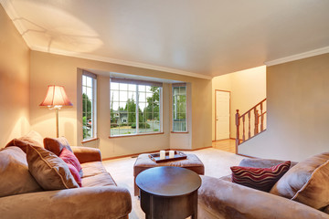 Lovely sitting room with mocha sofas and ottoman