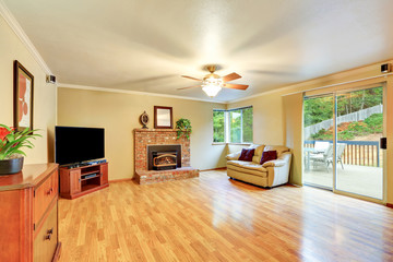 Cozy hardwood living room with glass door exit to the deck