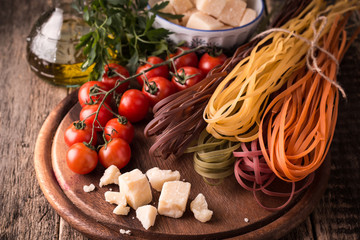  Vegetable color Pasta, oil,tomatoes,cheese on wooden table. italian food