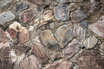 real medieval stone wall surface can use as background pattern or texture with real light at old town Songkhla Thailand (vintage style)
