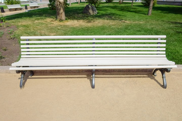 White bench in the park in the summer