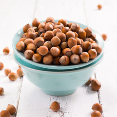 Hazelnuts on rustic wooden background