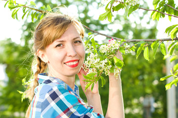 Portrait of a girl with a bird-cherry tree