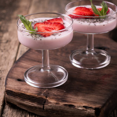 Healthy breakfast or morning snack with chia seeds strawberries yogourt vegetarian food, diet and health concept