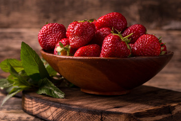 Ripe red strawberries on vintage wooden table