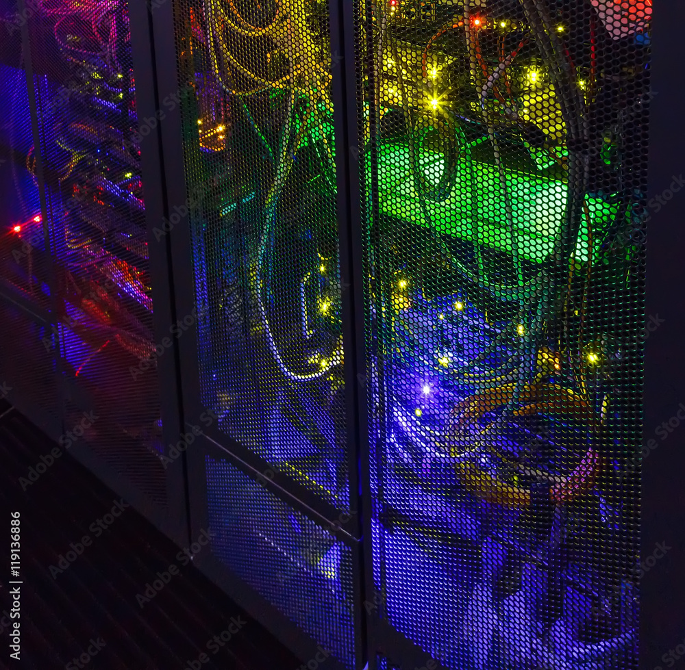 Aufkleber part of mainframes with wires and lighting in data center