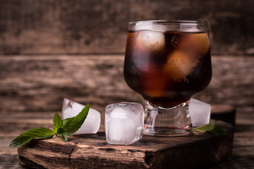 cold drink with ice on wooden vintage table