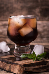 cold drink with ice on wooden vintage table